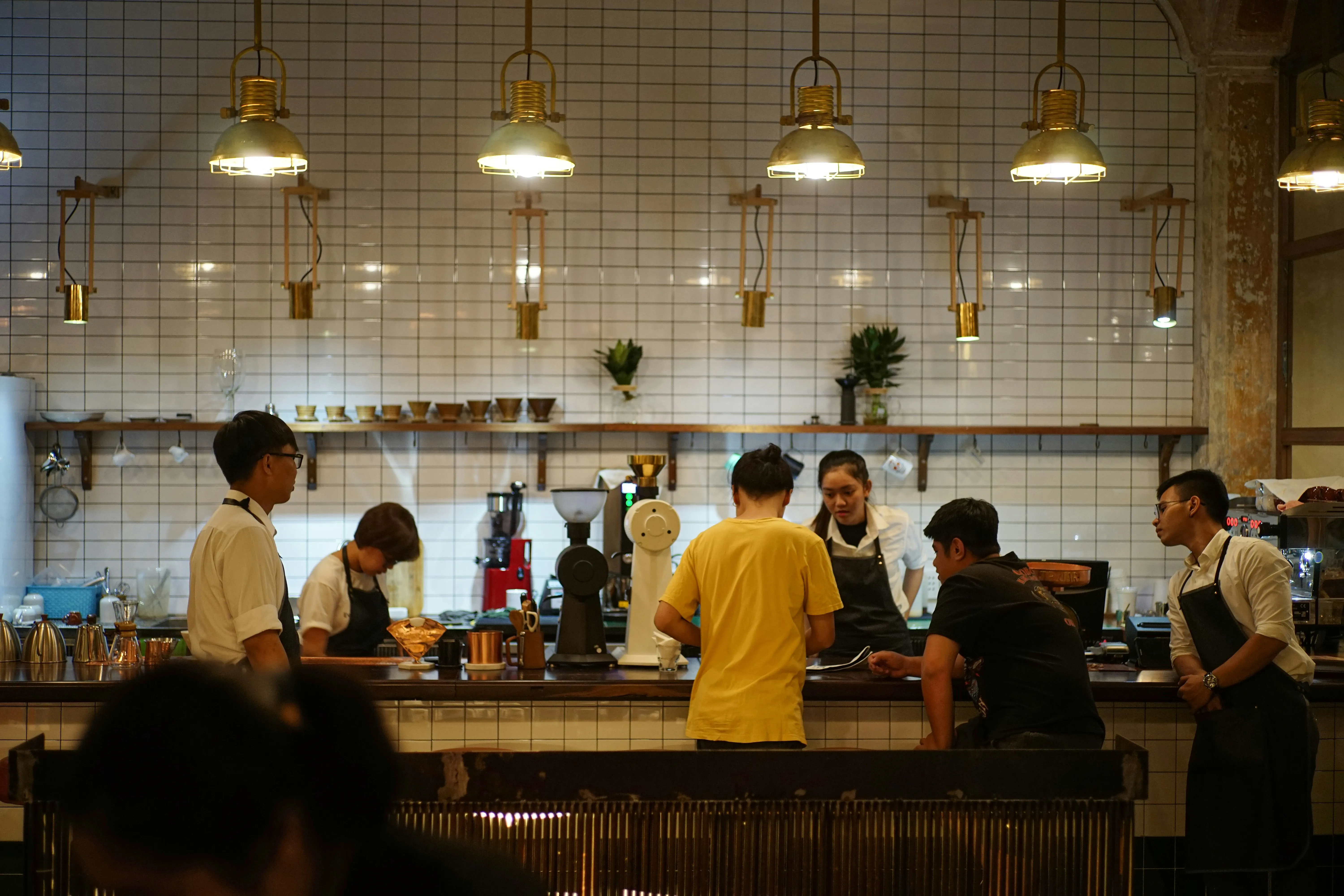 Hotel restaurant kitchen with chefs at work — commercial kitchen fire risk including extraction systems and high-heat cooking equipment