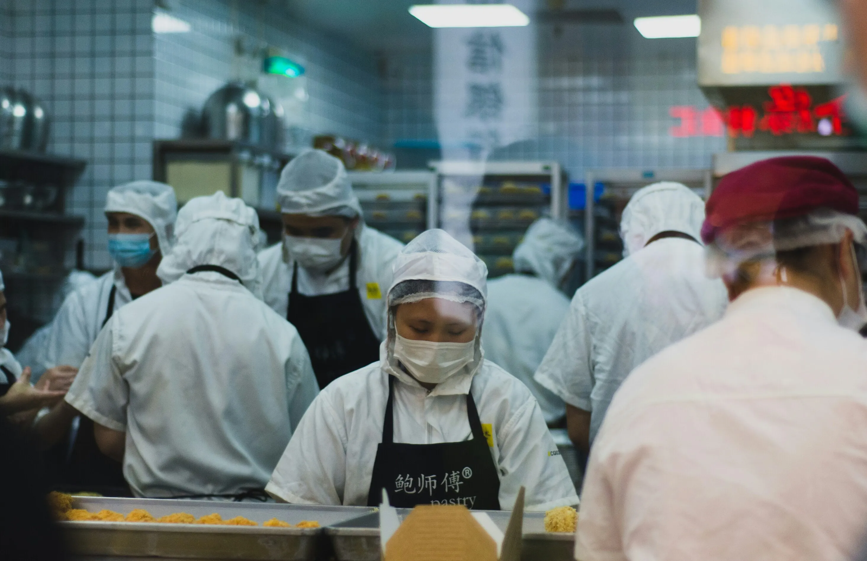 Two food safety inspectors examining kitchen equipment — internal audit blind spot in multi-site hospitality operations
