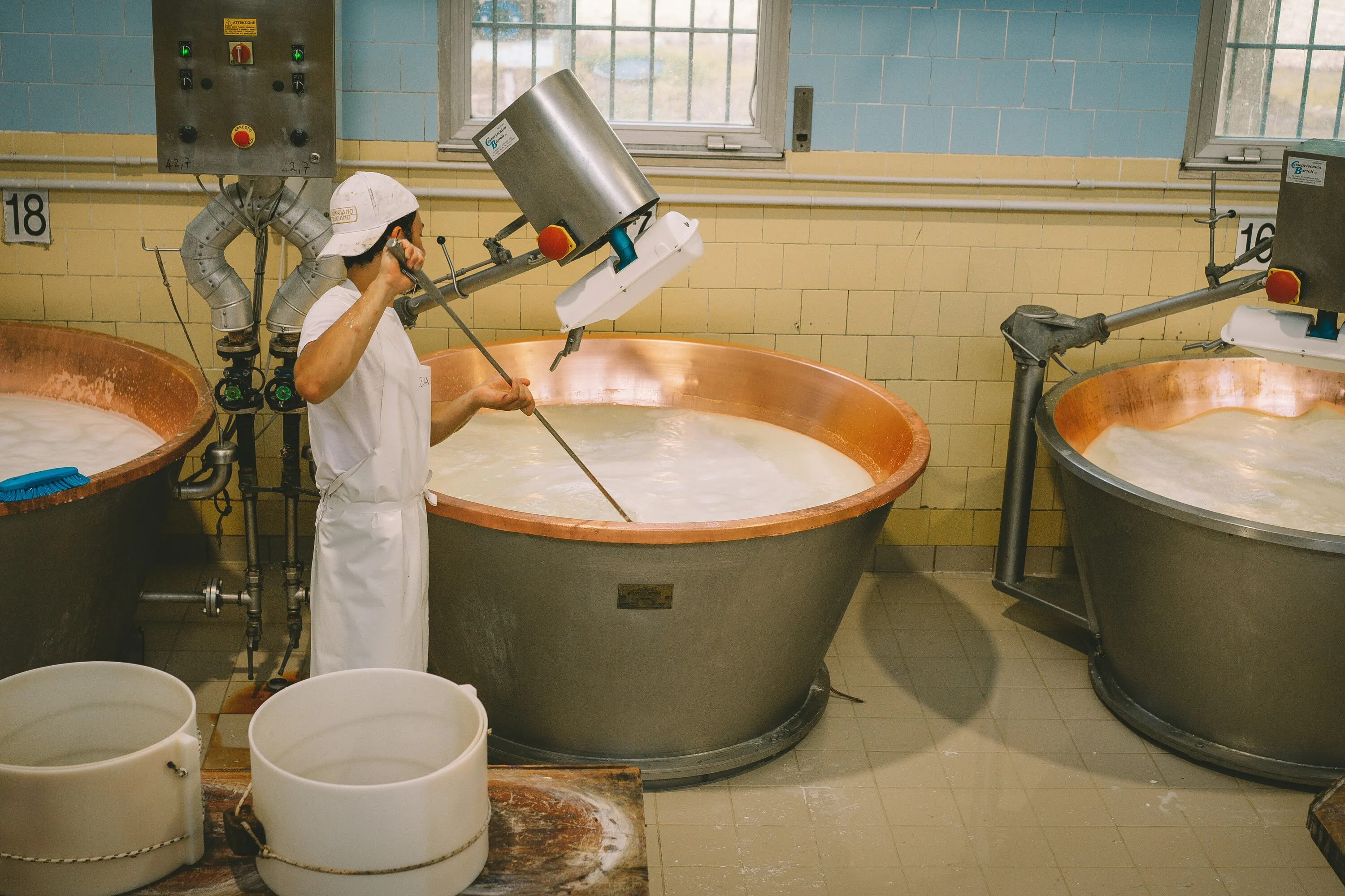 Food production worker operating hygiene-compliant processing equipment — independent food safety assessment for multi-site hospitality operators