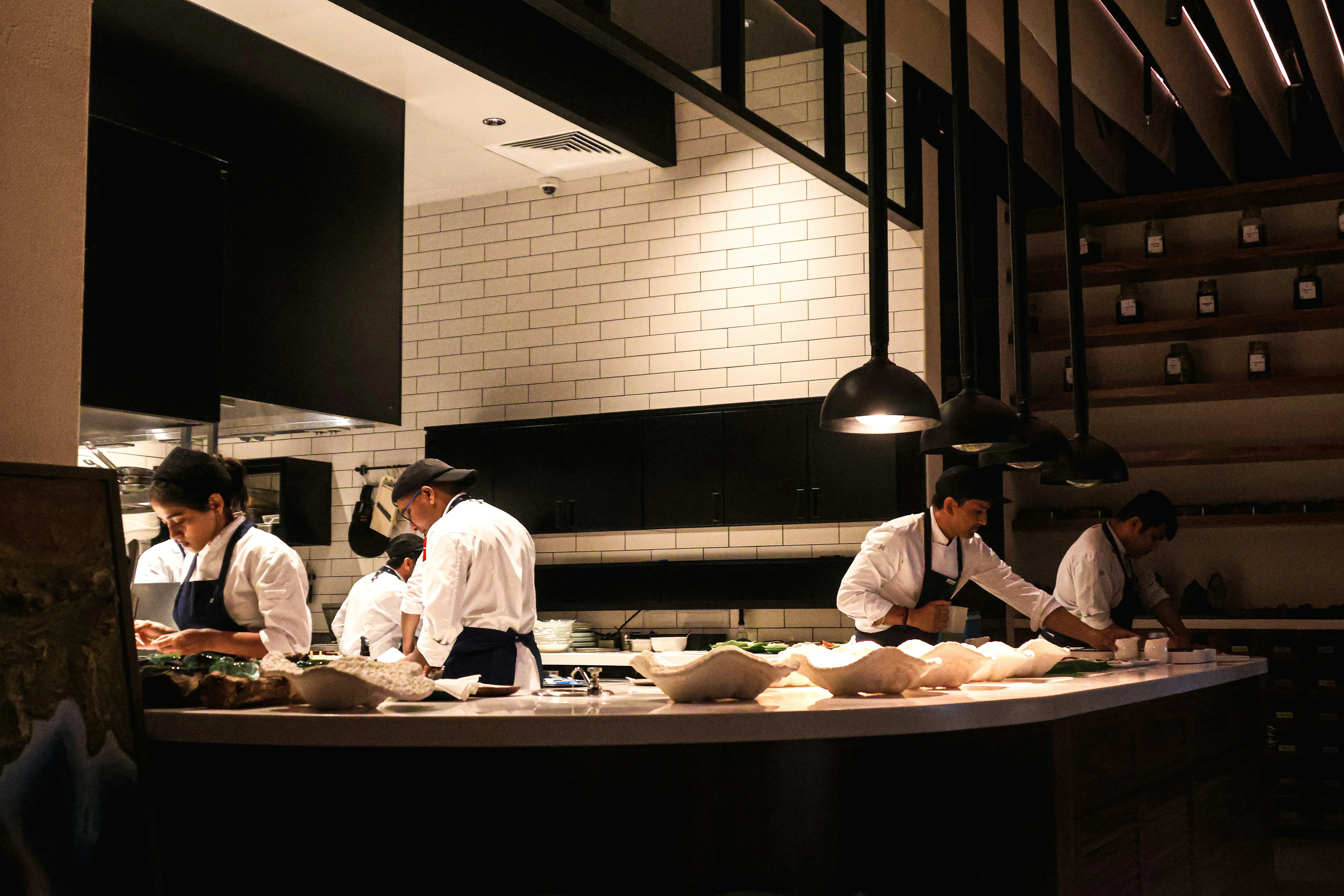 Hotel kitchen team during service — food safety due diligence as part of hotel compliance audit