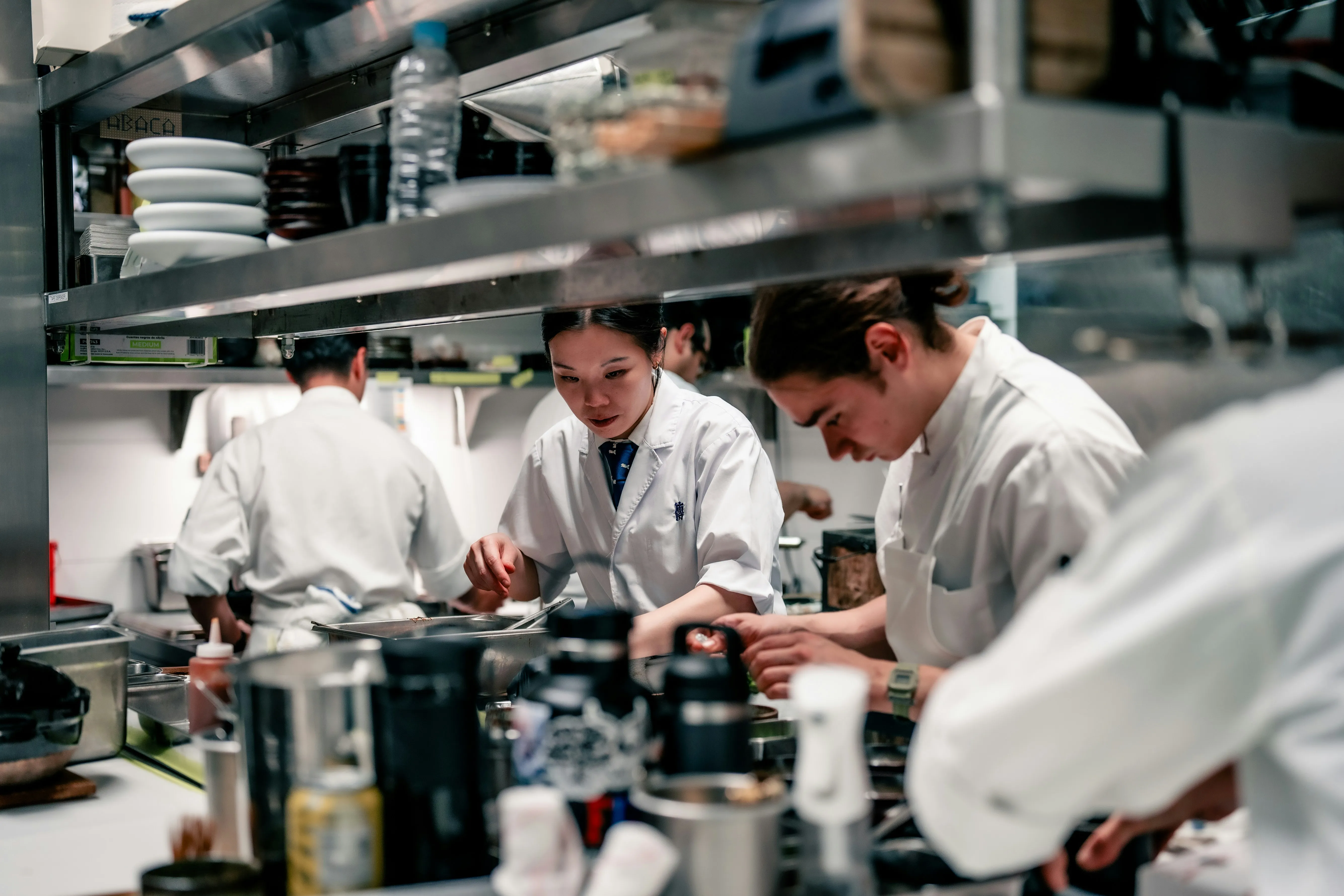 Multi-site hospitality kitchen team during service — why a generic annual food safety audit answer does not fit every site