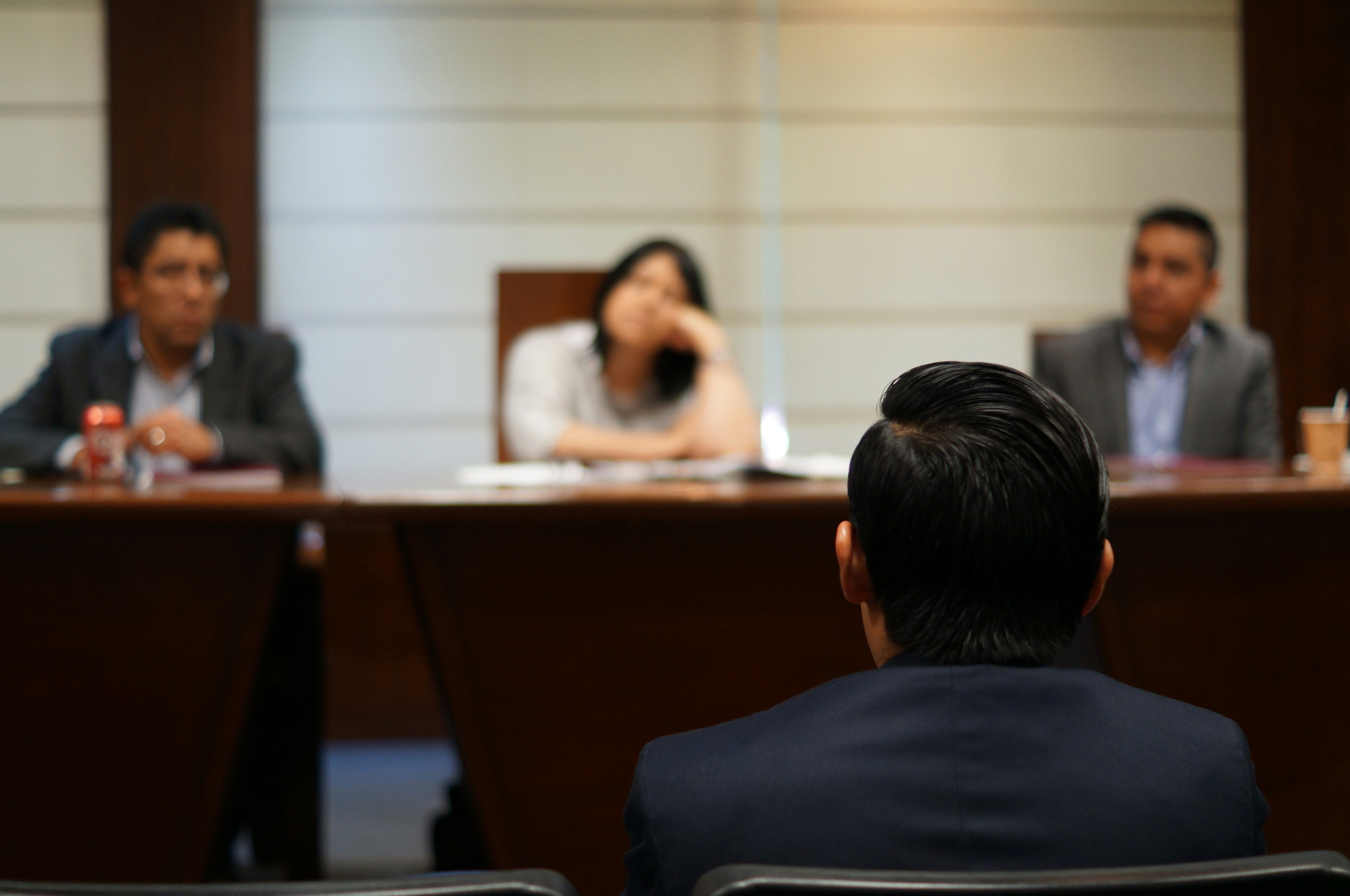 Director facing a board panel — personal liability for operational compliance failures under Health and Safety at Work Act 1974 and corporate manslaughter legislation