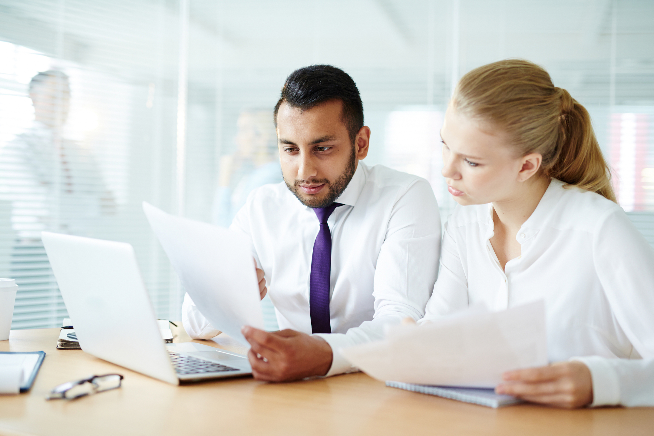 Two professionals reviewing H&S compliance documentation — why health and safety gets overlooked behind food safety assurance in hospitality operations