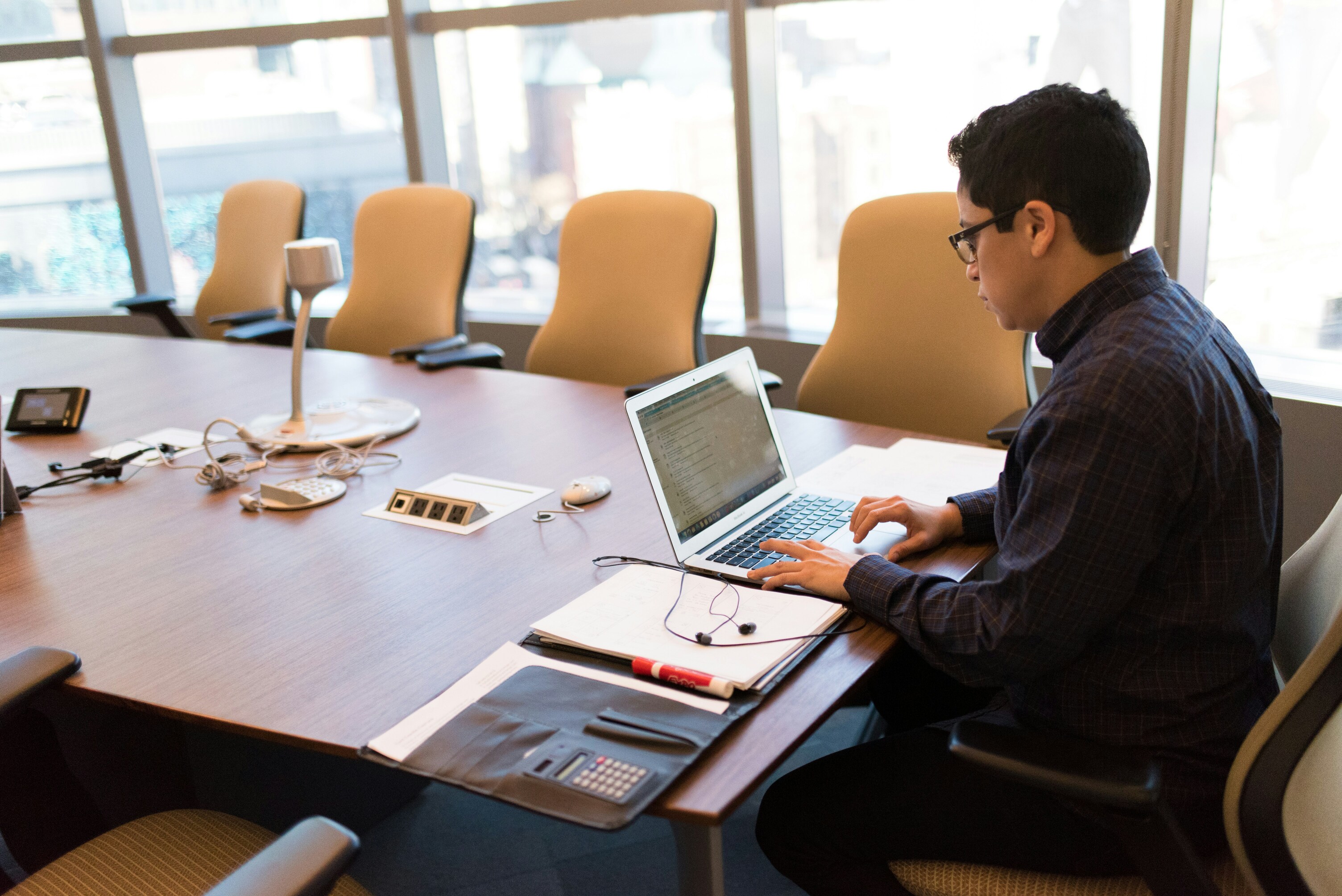 Operations director reviewing health and safety audit programme at a boardroom table — when to commission a hospitality H&S audit after a change in senior leadership