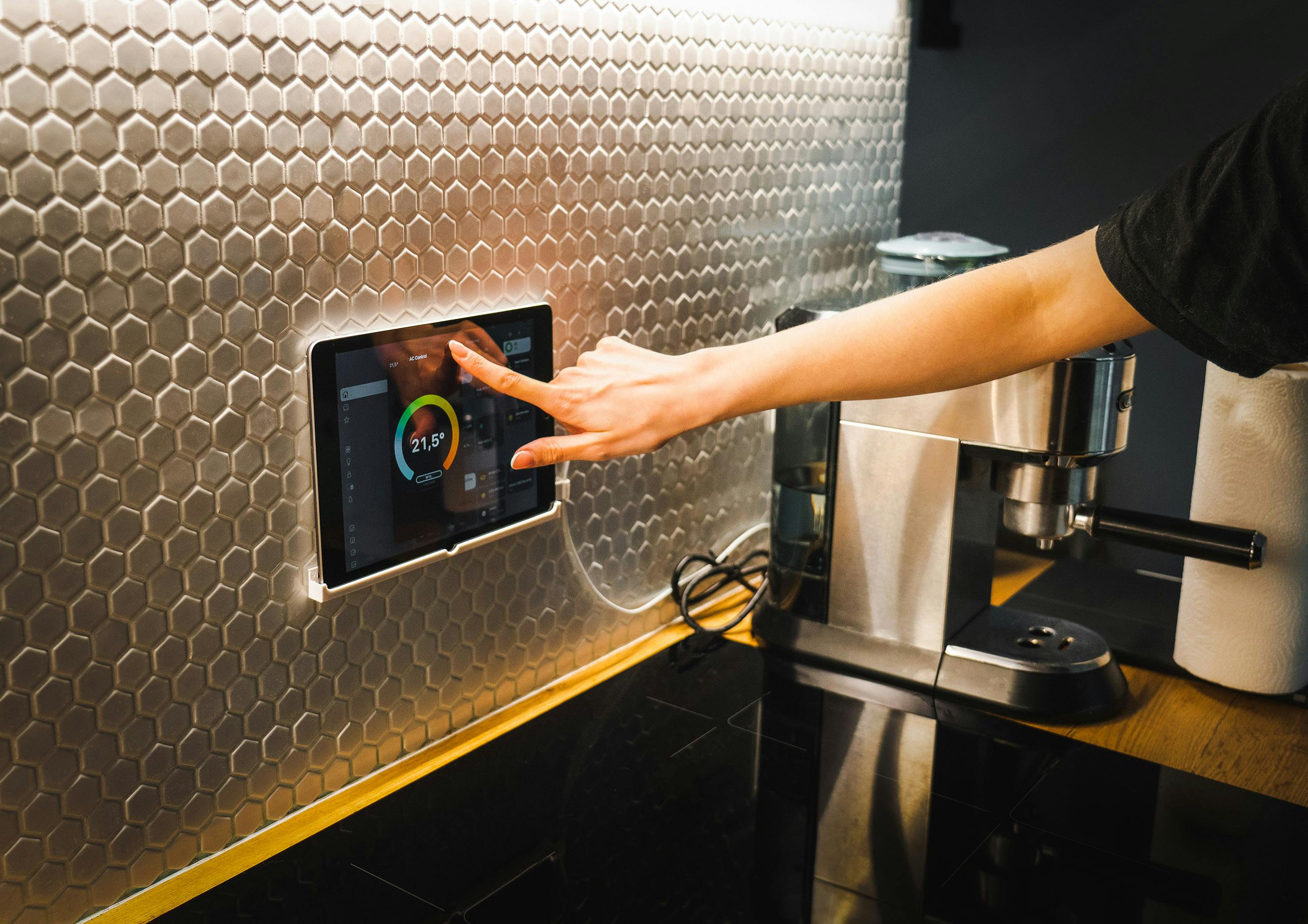 Kitchen staff checking temperature monitoring system — where QSR food safety compliance breaks down across franchise estates through cooling failures and backfilled temperature logs