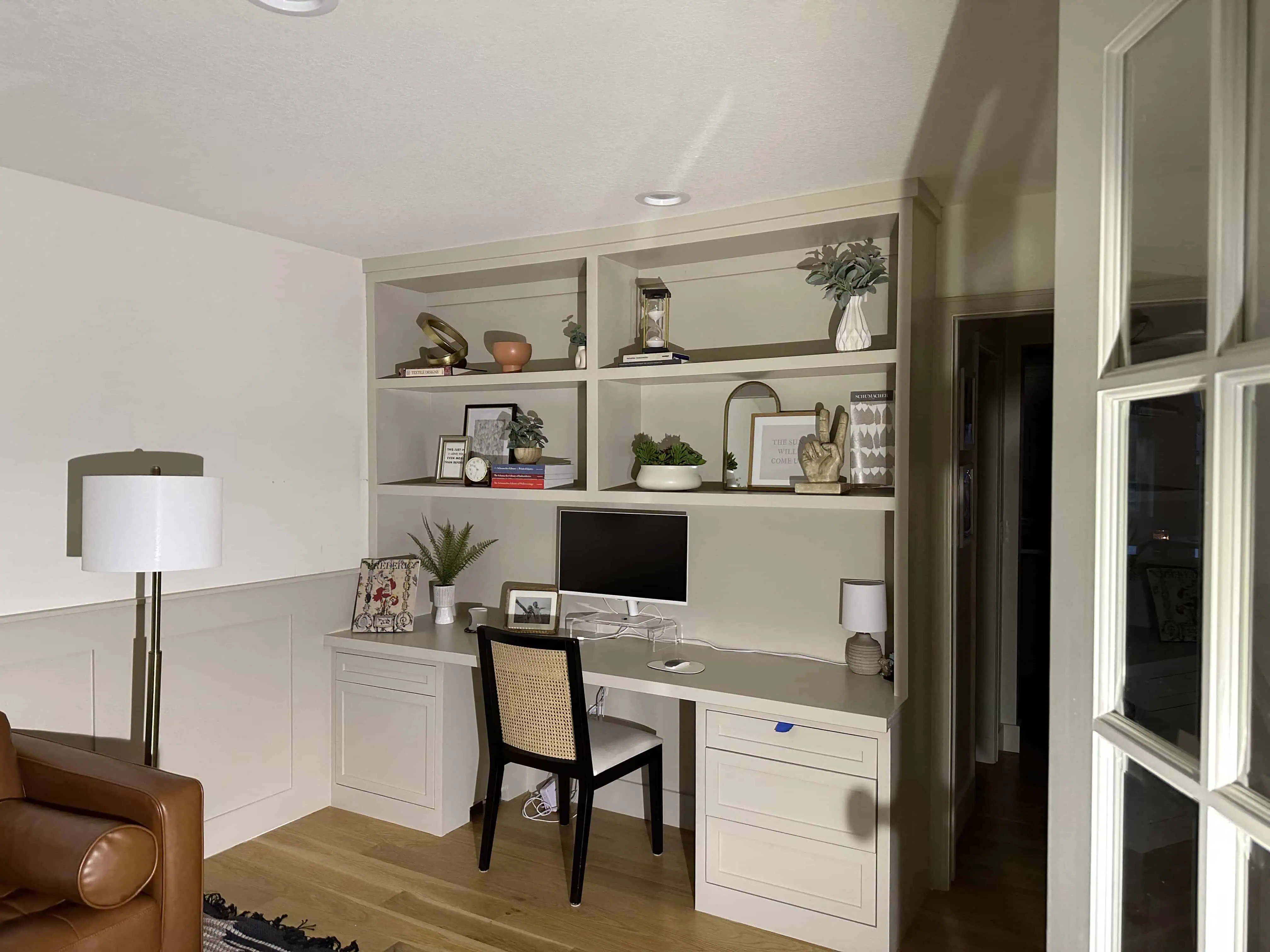 Home office with built-in shelving and desk in Denver house renovation by Blue Mountain Remodeling, featuring modern decor and ample storage space.