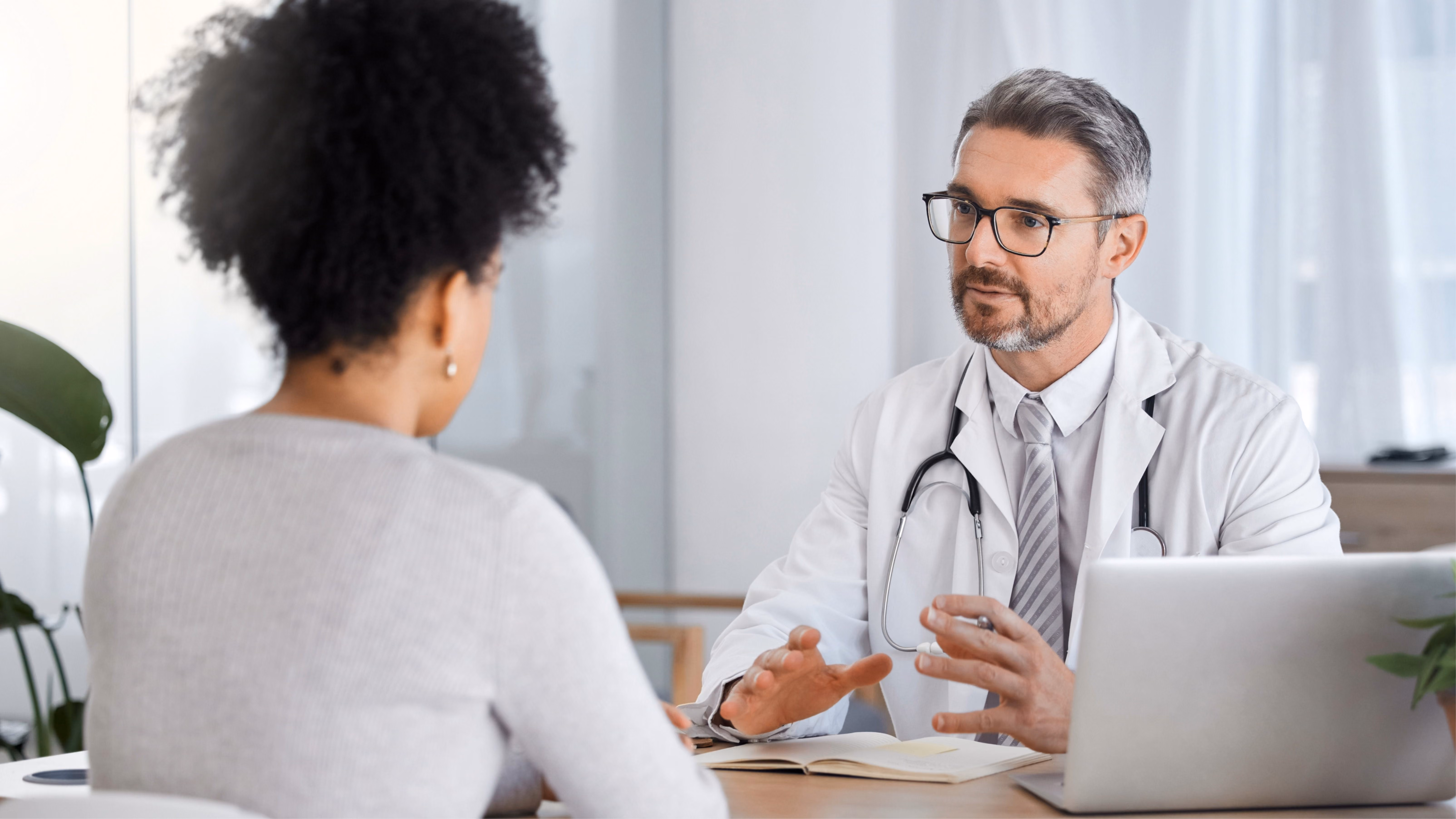 Patient attending an appointment with a neuroendovascular surgeon in West Hills, CA, discussing diagnosis, treatment options, and personalized care during a medical consultation in a modern clinic setting.