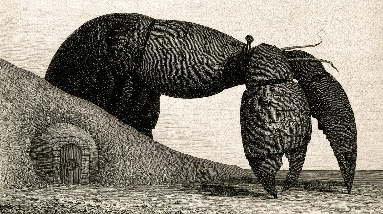 Victorian-style engraved illustration: a great iron-plated lobster standing guard over a small vault door in the hill