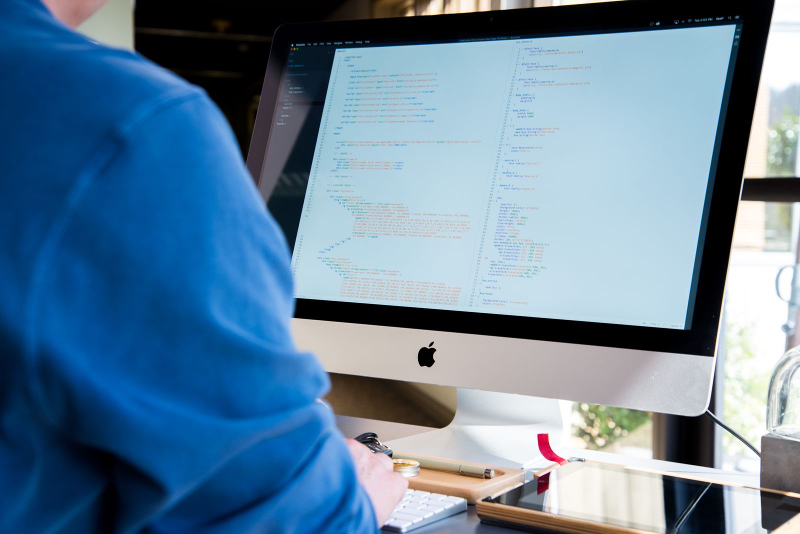 Developer coding on a desktop computer