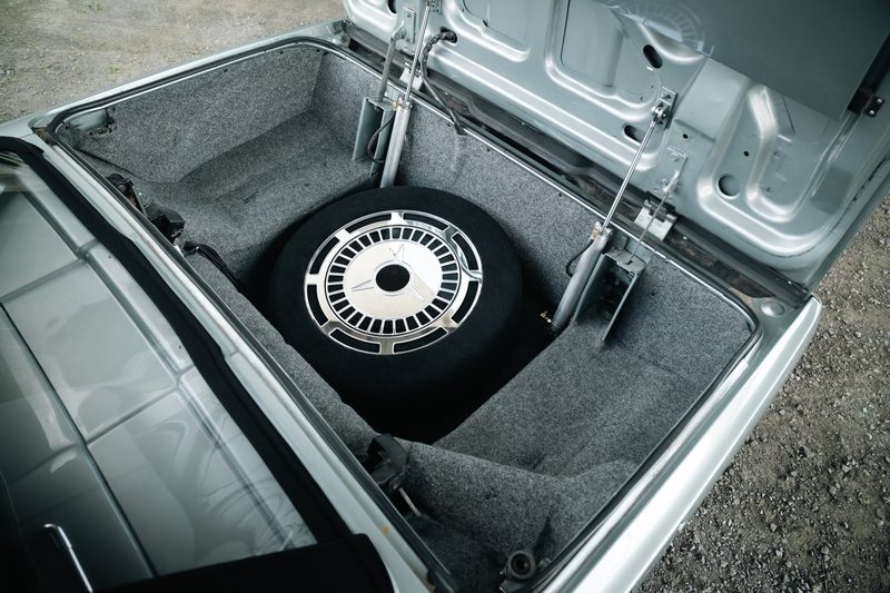 Custom subwoofer enclosure built as a spare tire in a 1964 Thunderbird trunk