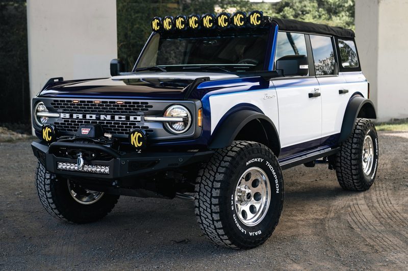 Wrap lines, painted blue grille and chrome script on a Ford Bronco