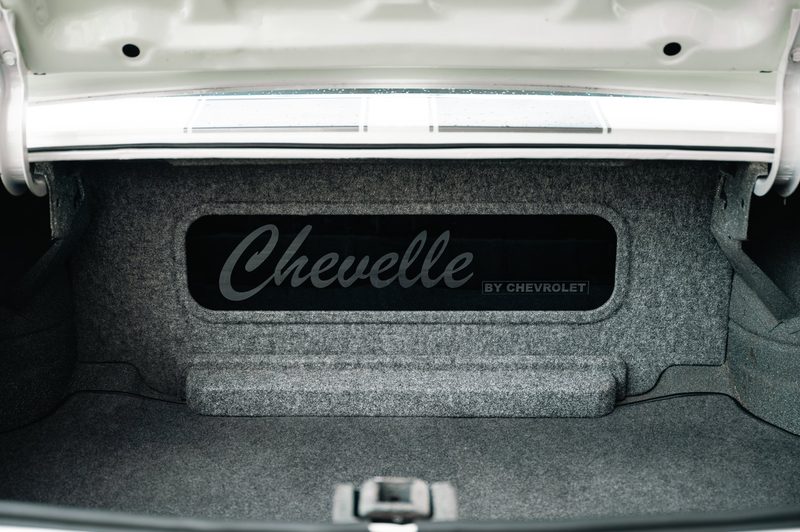 Etched Chevelle glass trunk panel that hides the subwoofer enclosure