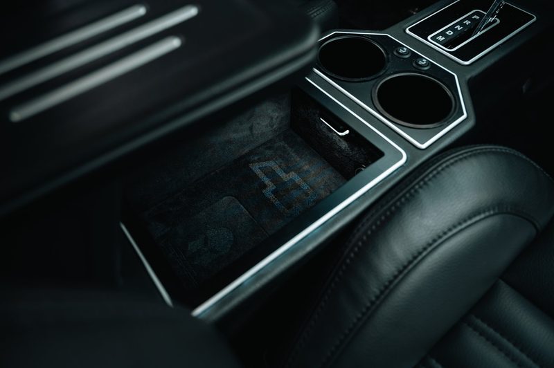 Suede-lined console storage with etched bowtie in a 1972 Chevelle