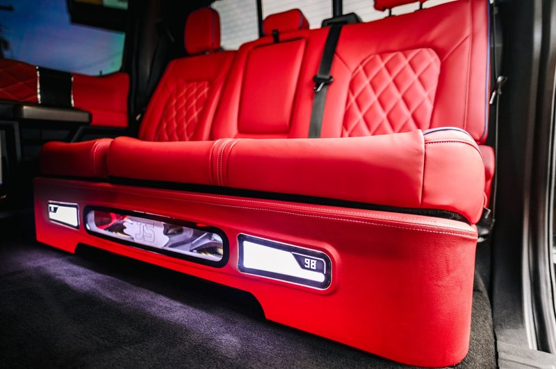 Red leather rear bench with illuminated underseat audio build in a Ford F-350
