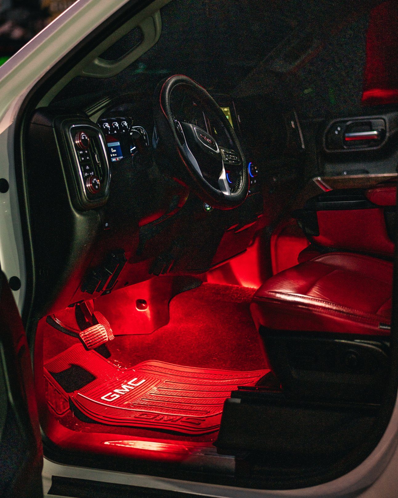 GMC Sierra cabin at night with red ambient footwell lighting, Titan Motoring