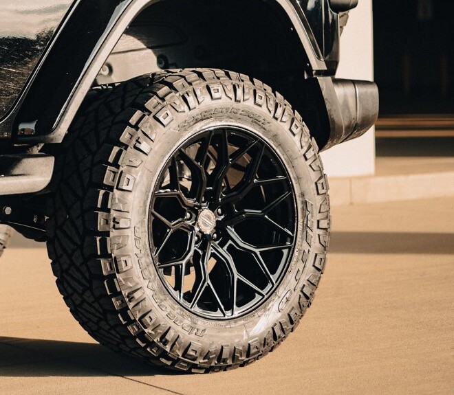 Gloss black Vossen HF2 20x10.5 wheel with a 35 inch Nitto Ridge Grappler on a Jeep Wrangler