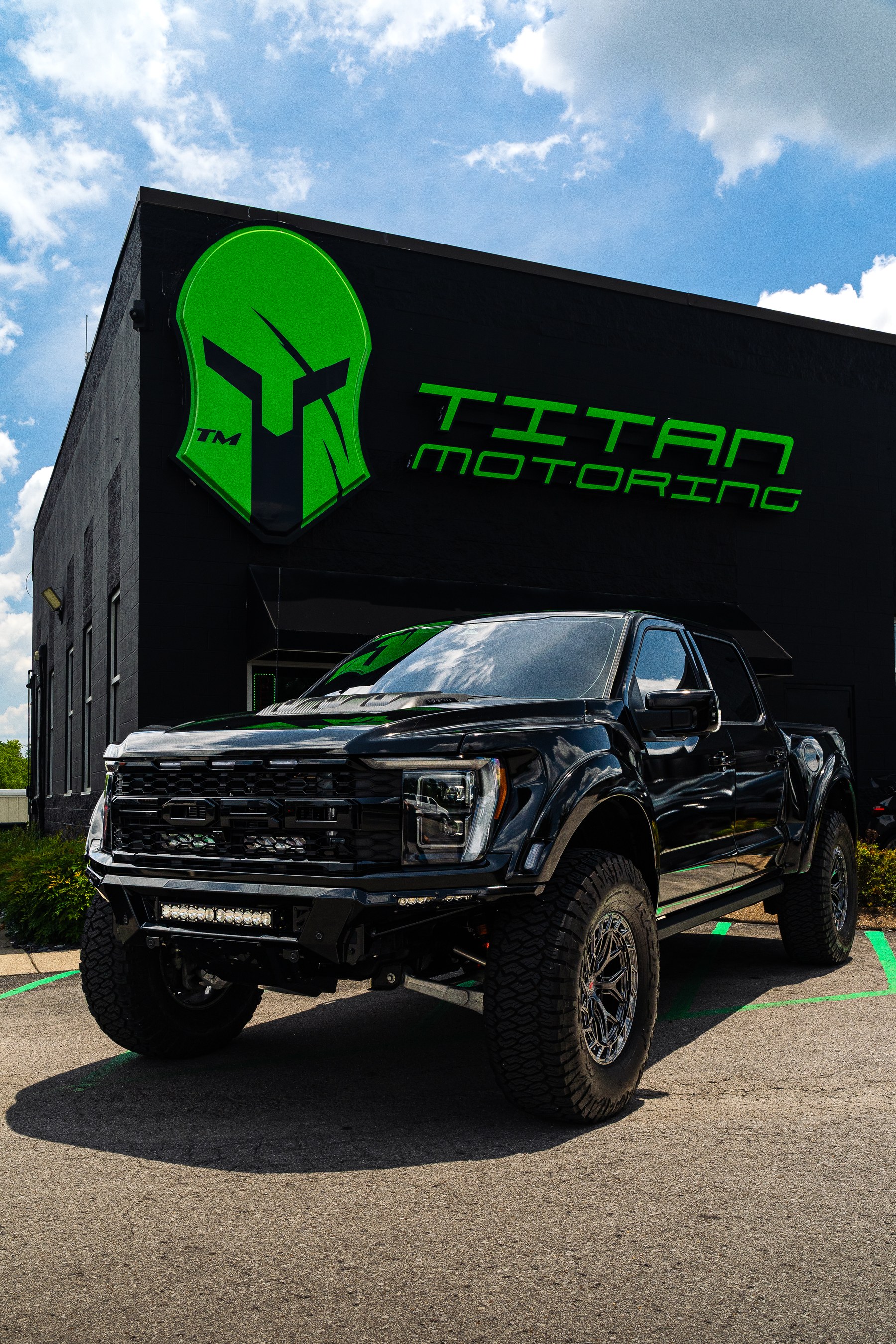 Ford F-150 Raptor R wrapped in KPMF Gloss Phantom Black Metallic with Fiberwerx widebody fenders