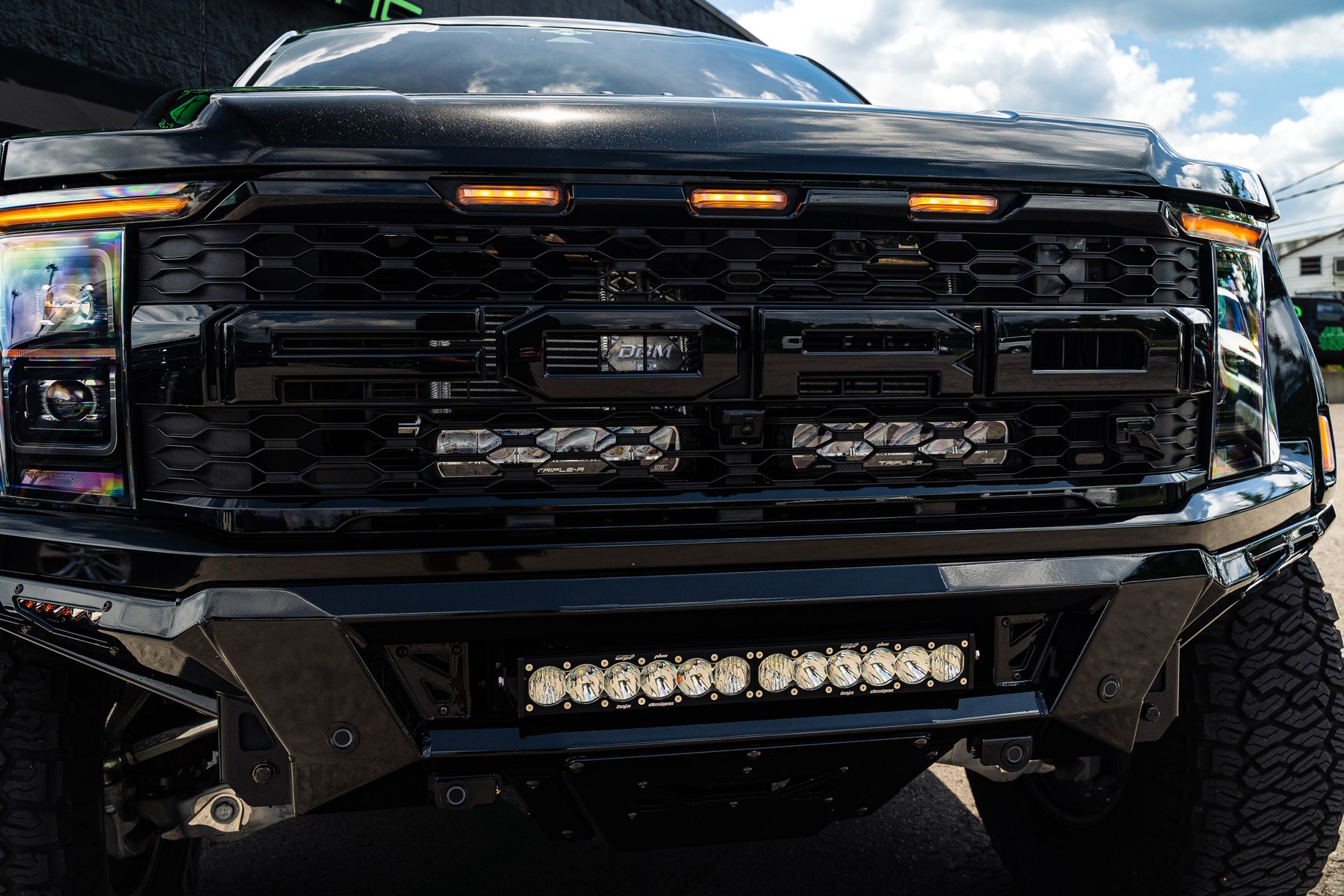 Addictive Desert Designs Phantom front bumper with Baja Designs LED light bar on a 2023 Ford F-150 Raptor R