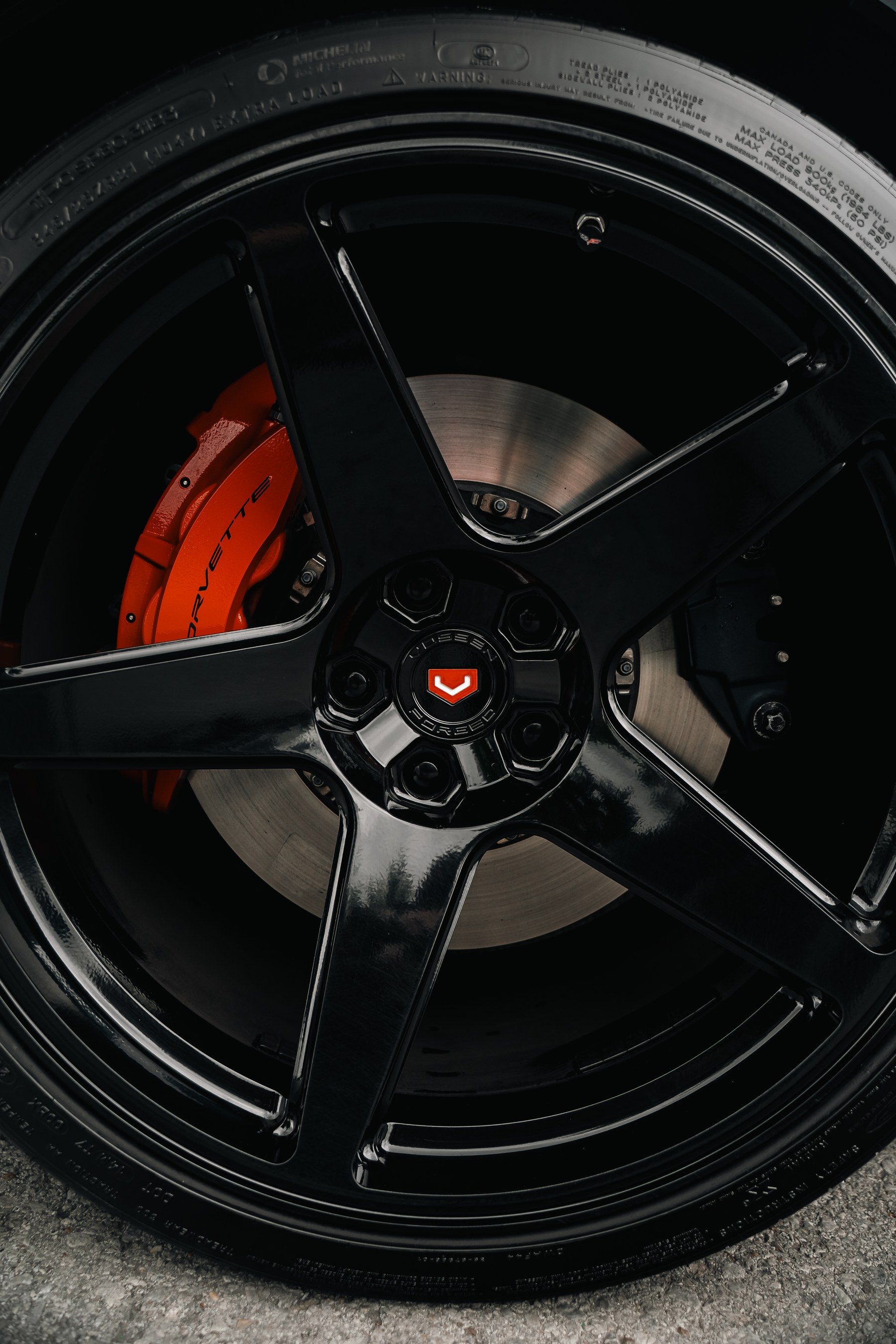 Vossen GNS-01 gloss black wheel with red brake caliper on a Chevrolet Corvette C8 Z06