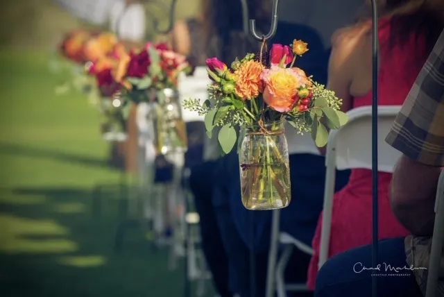 Outdoor wedding setup at Redlands Mesa Golf Course with floral decorations and scenic backdrop