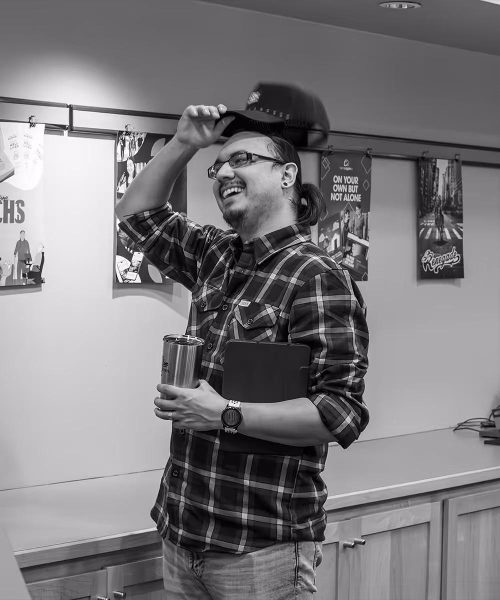 man taking cap off to scratch his head