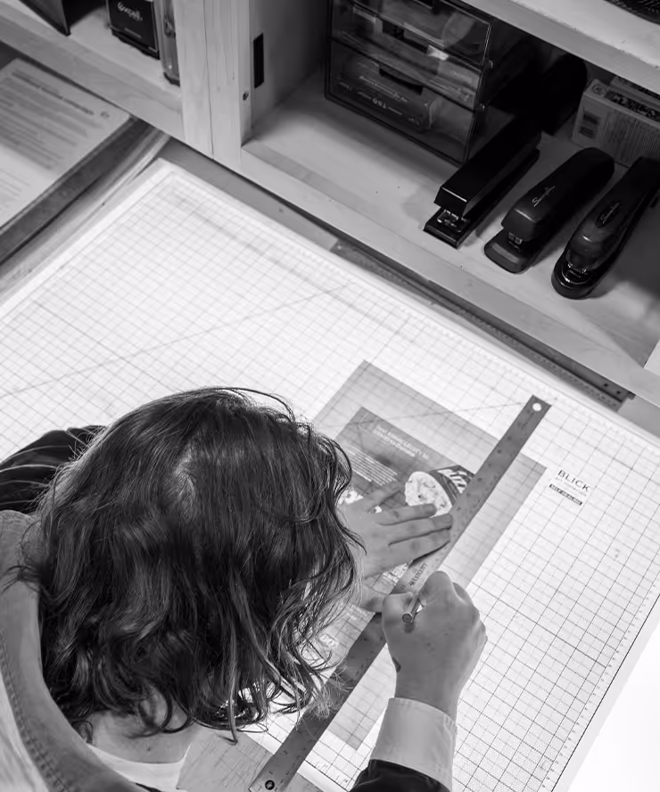 Man measuring out and cutting paper