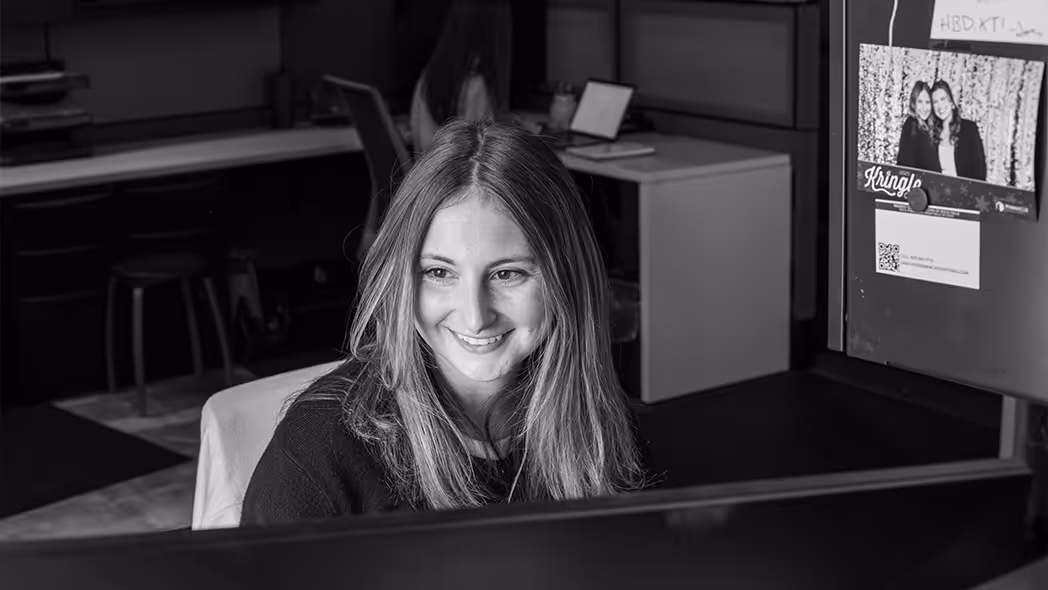 woman smiling while working at computer