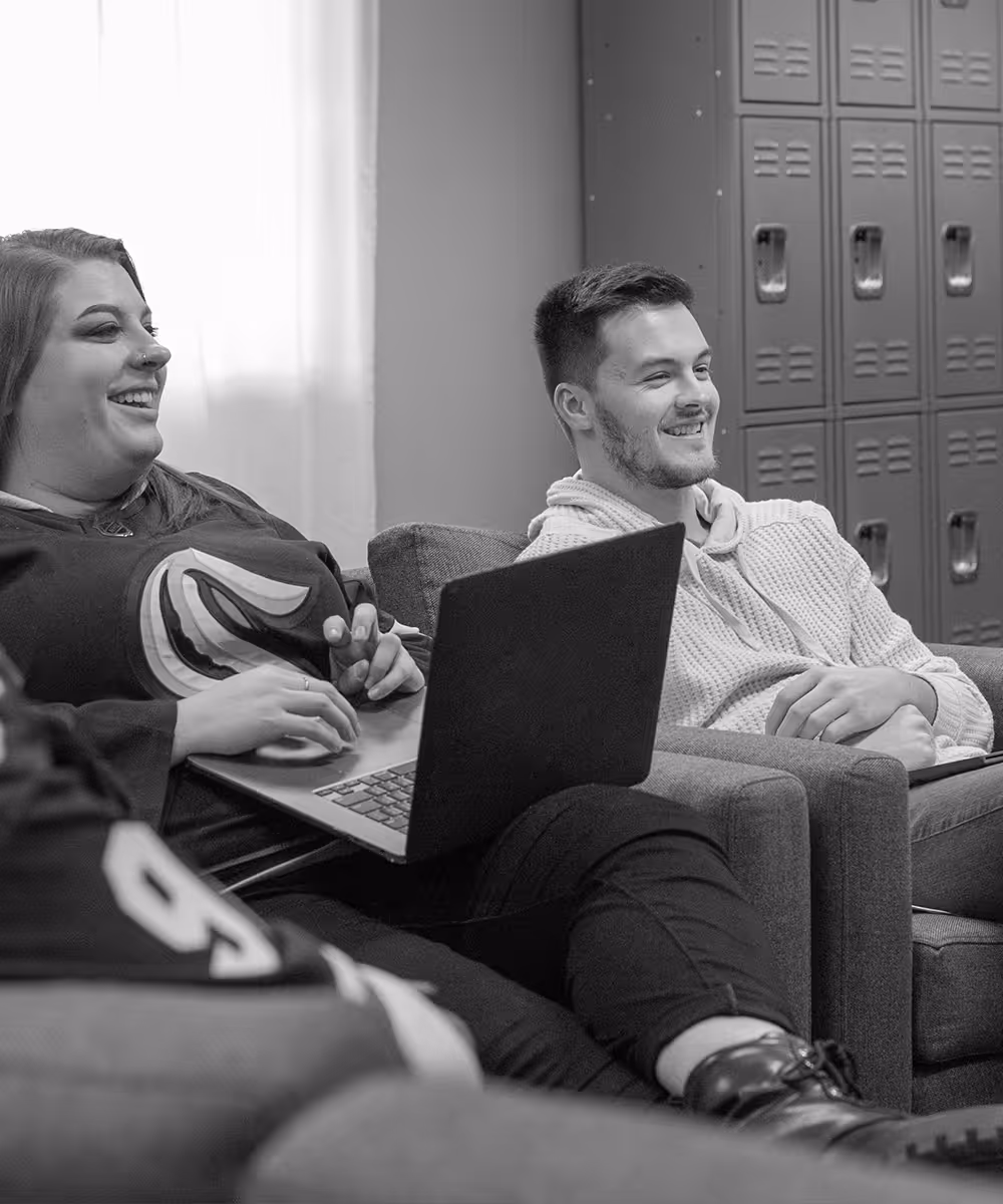 two Lawrence & Schiller employees having fun in a meeting