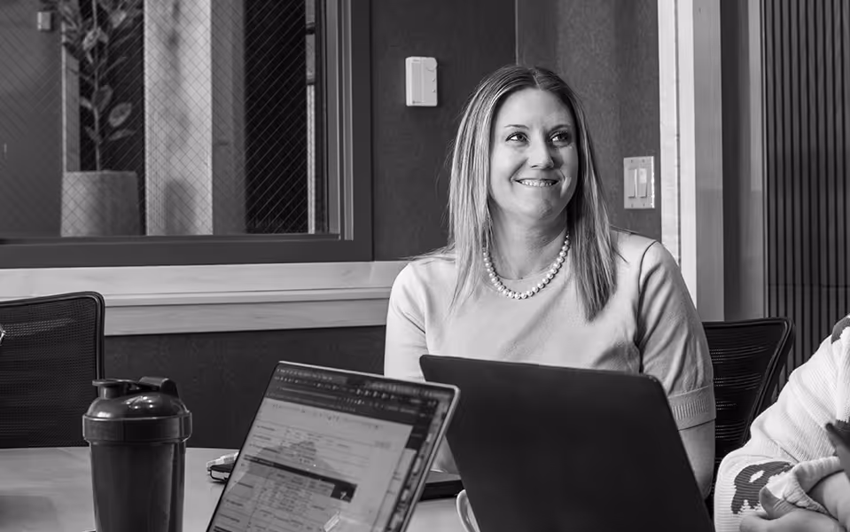 Laura Mitchell of Lawrence & Schiller smiling in a meeting
