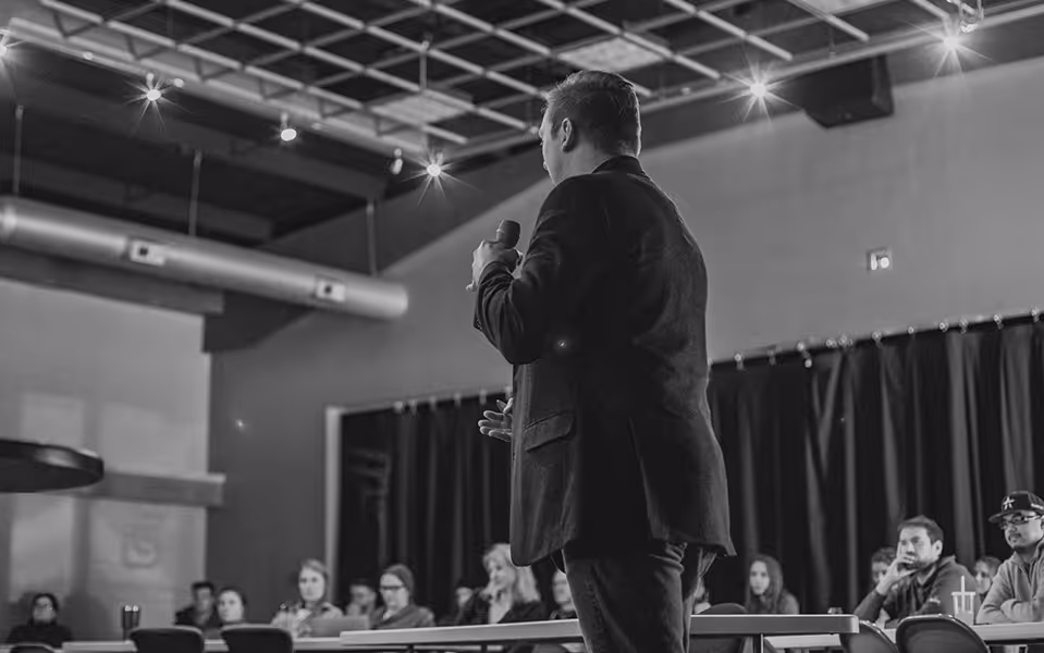 Travis Adney speaking at an engagement for Lawrence & Schiller