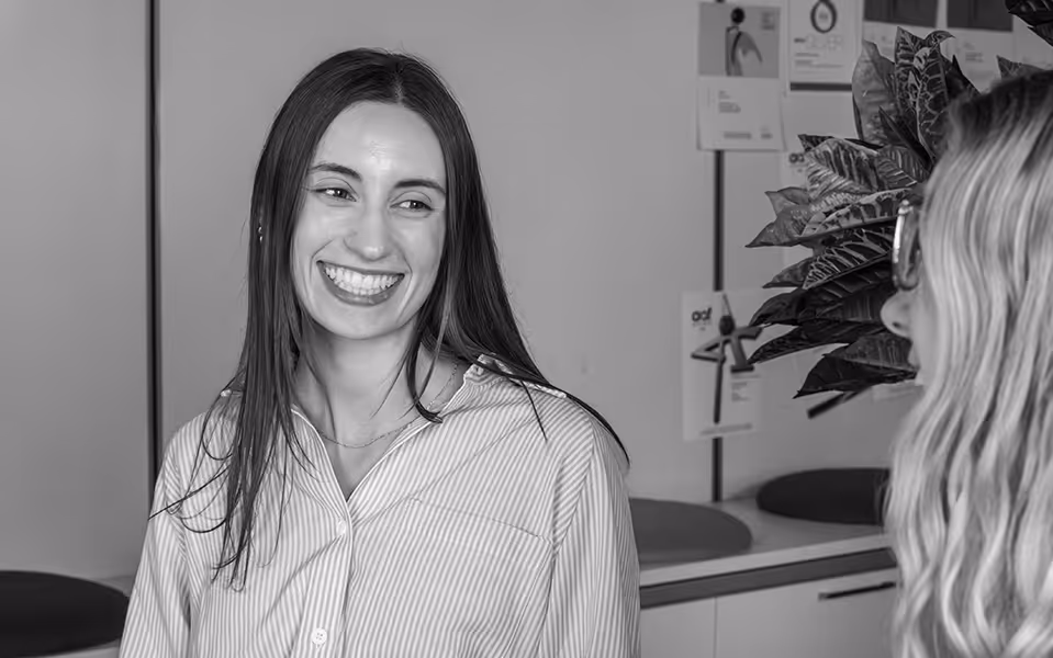 Lawrence & Schiller employee smiling and actively listening to peers