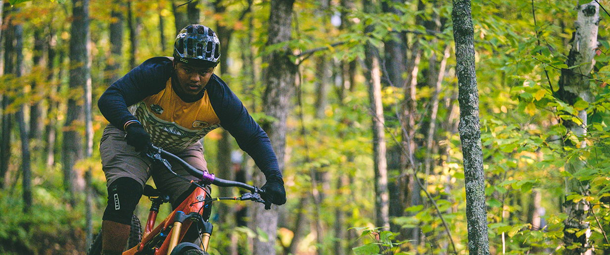 man riding a bike through forests | Lawrence & Schiller Creative Case Studies - Visit Duluth, City of Duluth