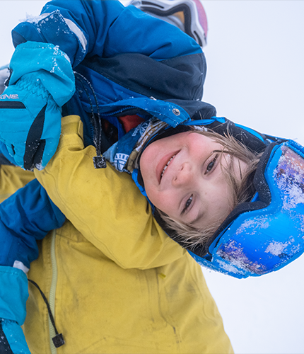child being held upside down playing in the snow | Lawrence & Schiller Creative Case Studies - Visit Duluth, City of Duluth