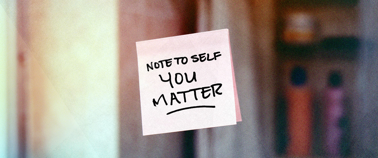 Sticky note on glass reading 'Note to self you matter' in black handwriting.
