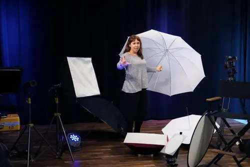 Person holding umbrella in studio class