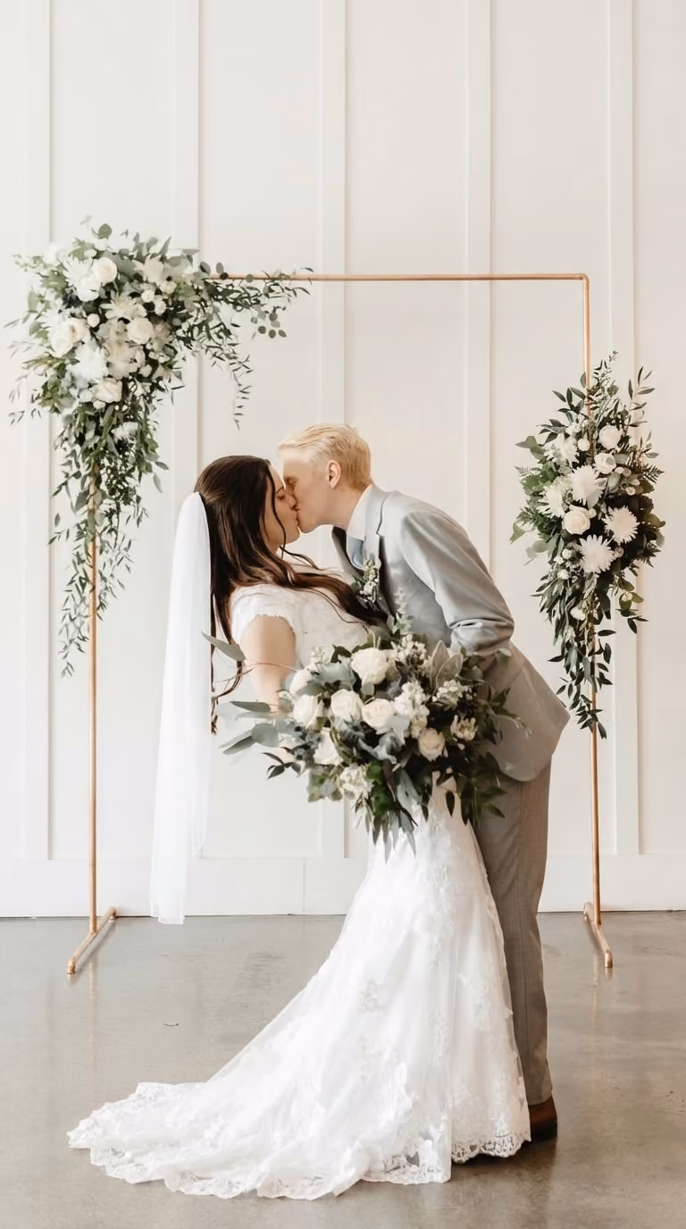 Romantic moment as a bride and groom share a kiss at their wedding reception