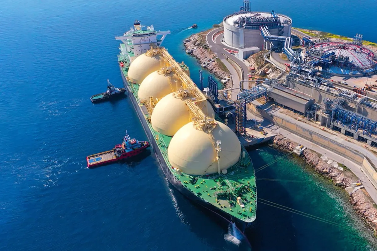 A liquefied natural gas carrier docked at an export terminal, seen from above