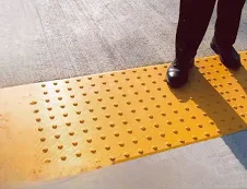 Alert-style ADA detectable warning surface tiles in cast-in-place format for high-visibility installations.