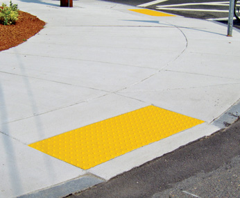 Cast-in-place ADA detectable warning surface tiles for curb ramps, crosswalks, and pedestrian access routes.