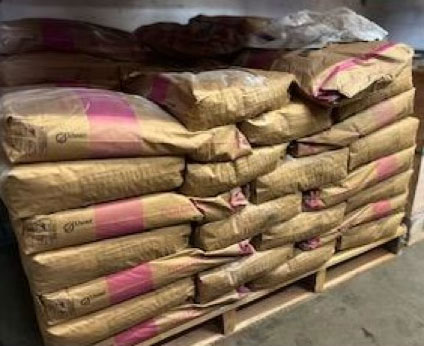 Bagged construction materials including grout, mortar, concrete mix, Portland cement, and specialty products.