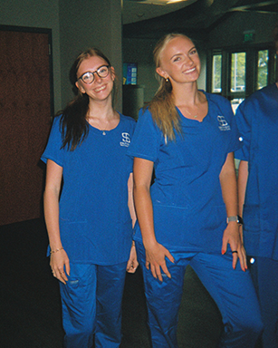 Two interns dressed in scrubs for a shoot