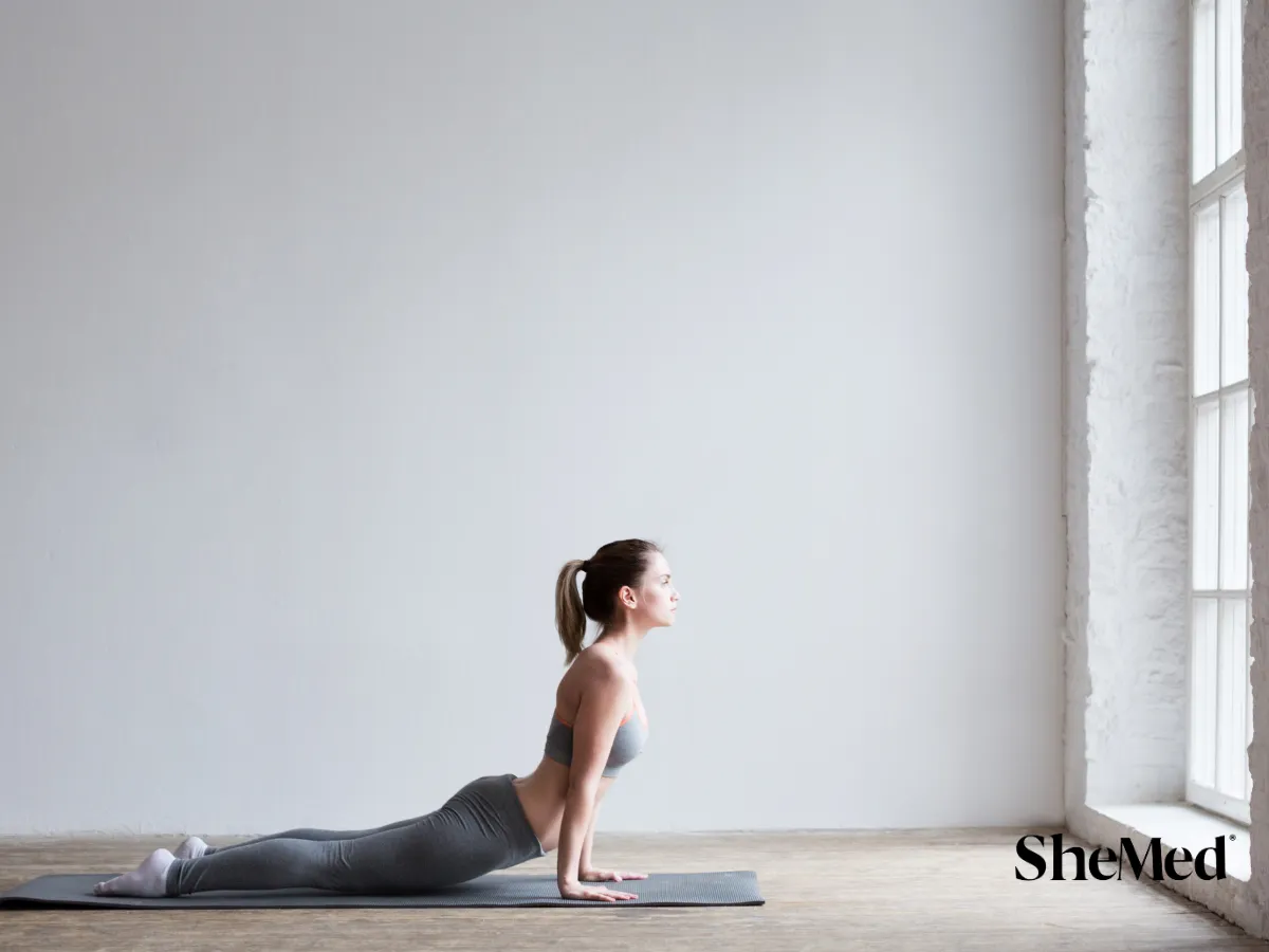 A women doing excersises in front of a window.