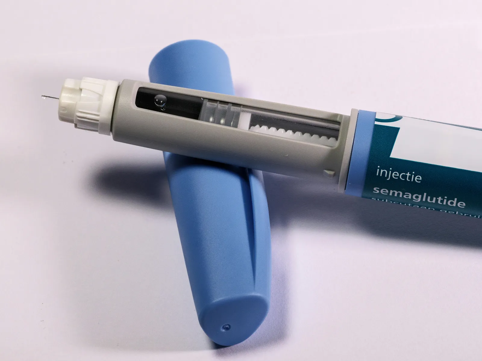 Detailed view of a semaglutide injection pen, commonly used for diabetes treatment, on a plain background.