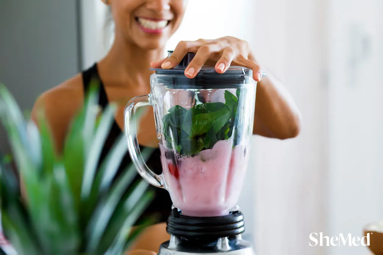 A women preparing a smoothie.