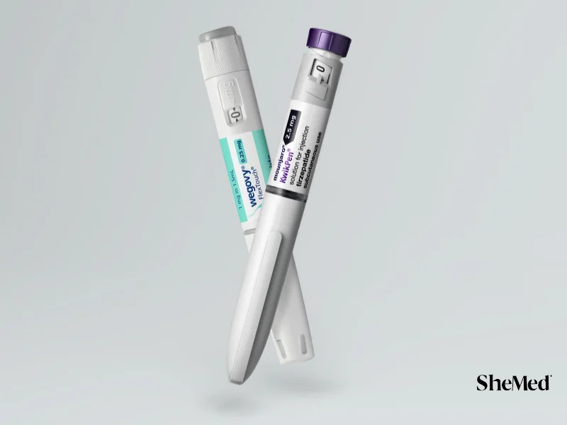 Wegovy and Mounjaro injectable weight loss medication pens crossed against a light grey background.
