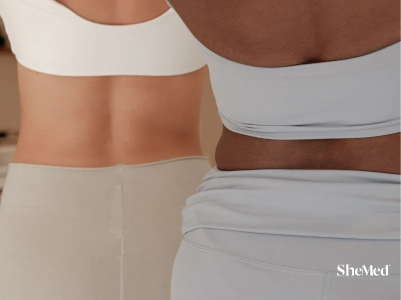 Close-up of two women with different body types standing side by side in activewear, representing body positivity.