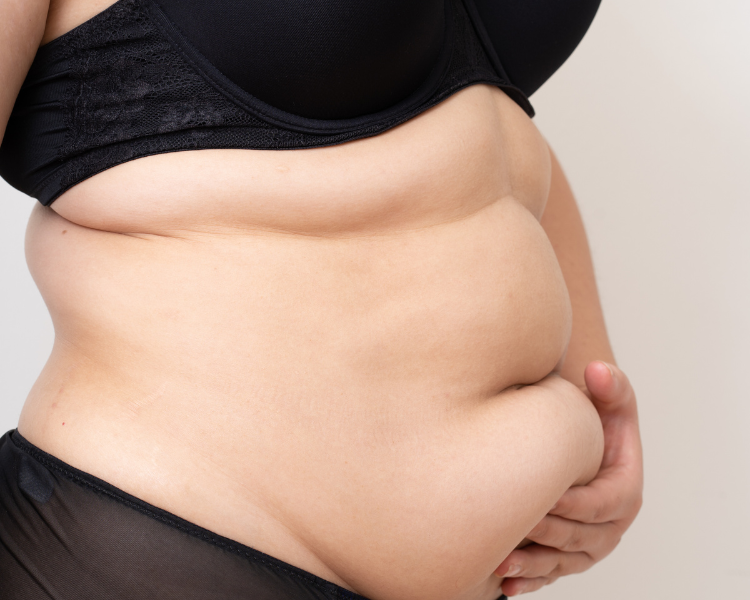 Female holding her stomach with her left hand