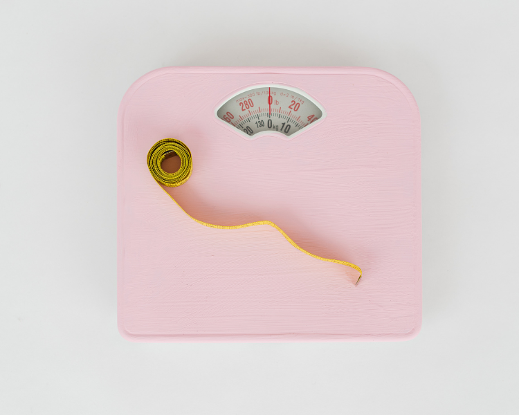 Pink scales with yellow measurement tape