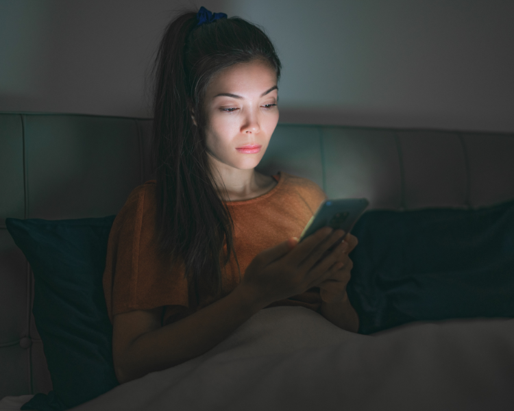 Women researching skinny jabs on her phone at night alone