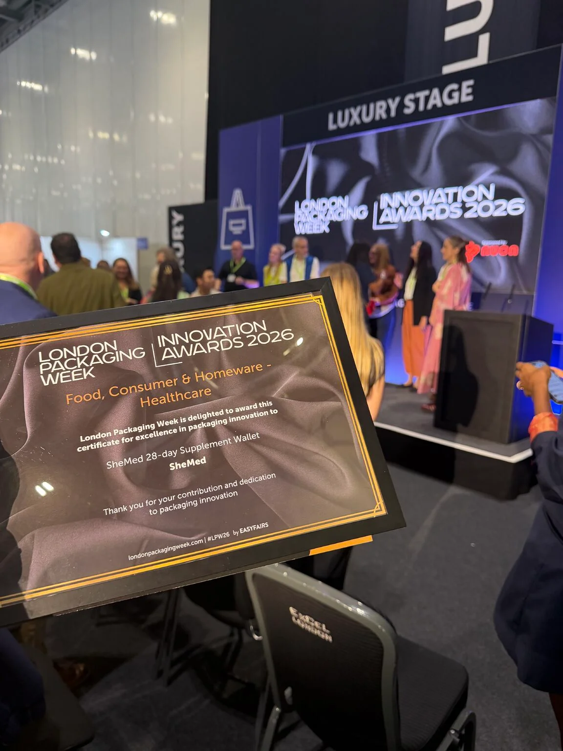 Certificate awarding SheMed's 28-Day Supplement Wallet Highly Commended in the Food, Consumer & Homeware, Healthcare category at the London Packaging Week Innovation Awards 2026, held at the ceremony stage.